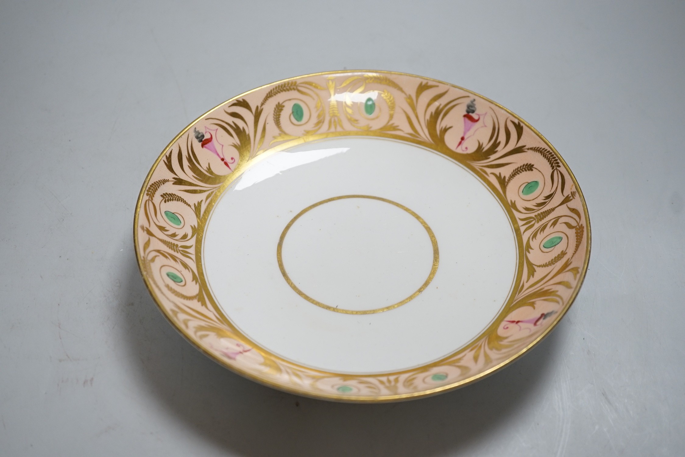 A 19th century Derby sucrier and cover and a matching saucer dish decorated in neo-classical style on a salmon coloured ground, red mark. 15cm tall overall